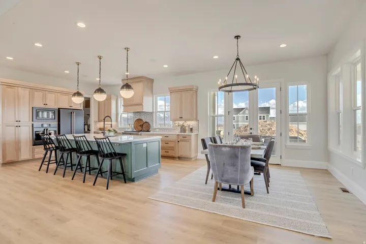 Open concept living area with light wood-finish flooring