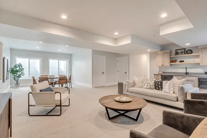 Spacious open-concept lower level with recessed lighting and light-colored carpeting
