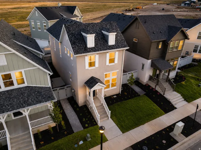 Contemporary two-story residence featuring a light-colored stucco exterior with white trim