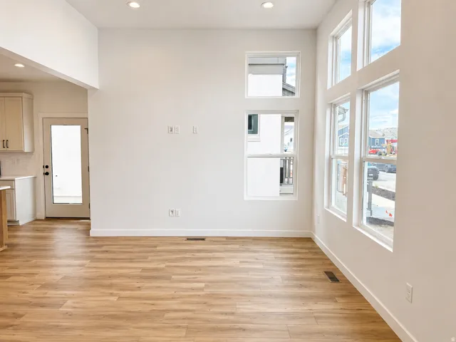 Expansive living area featuring tall ceilings and abundant natural light from multiple window types