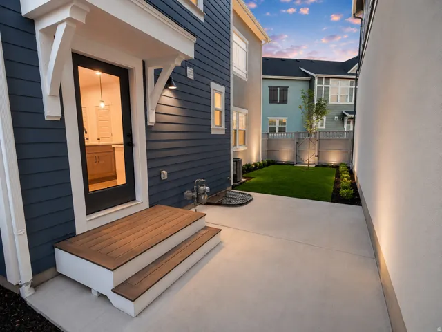 Private outdoor patio featuring a concrete surface and a manicured lawn