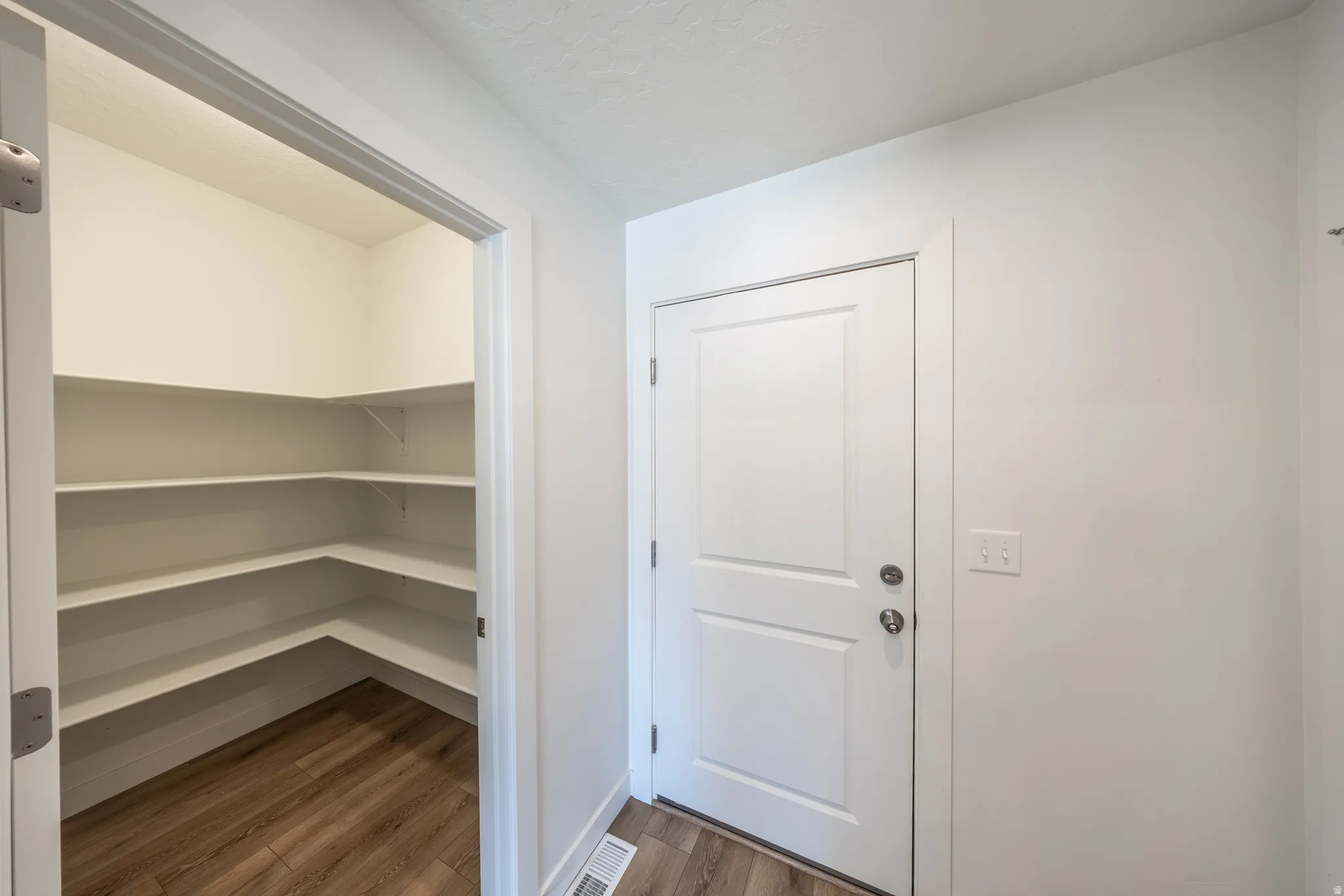 Door to garage next to pantry