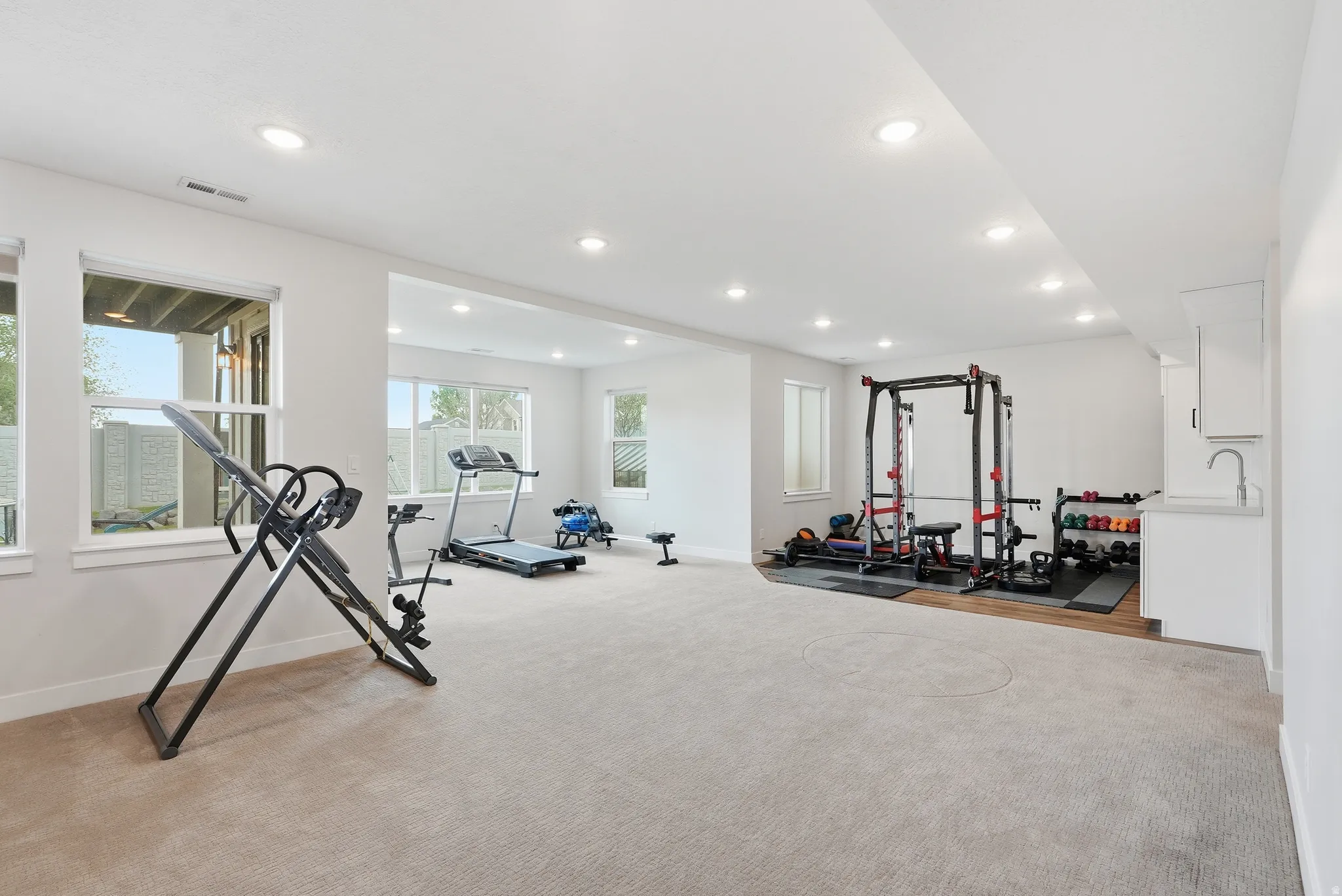 Spacious lower level featuring recessed lighting and light gray wall paint