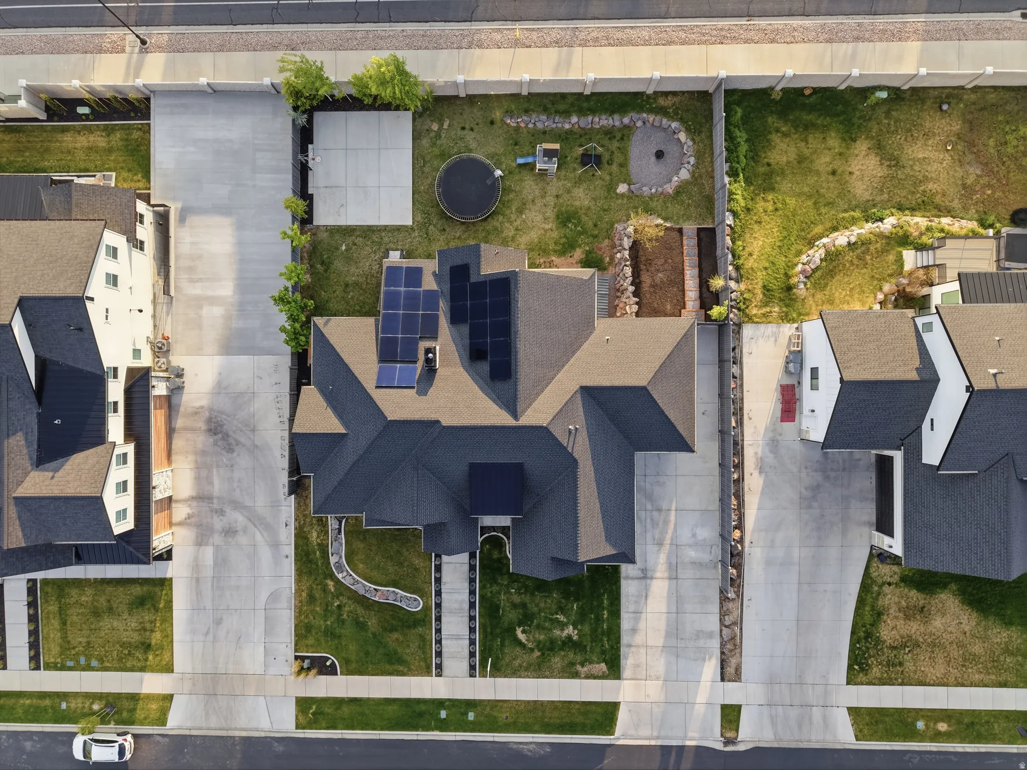 Aerial perspective showcasing a dark-tiled roofline with integrated solar panels
