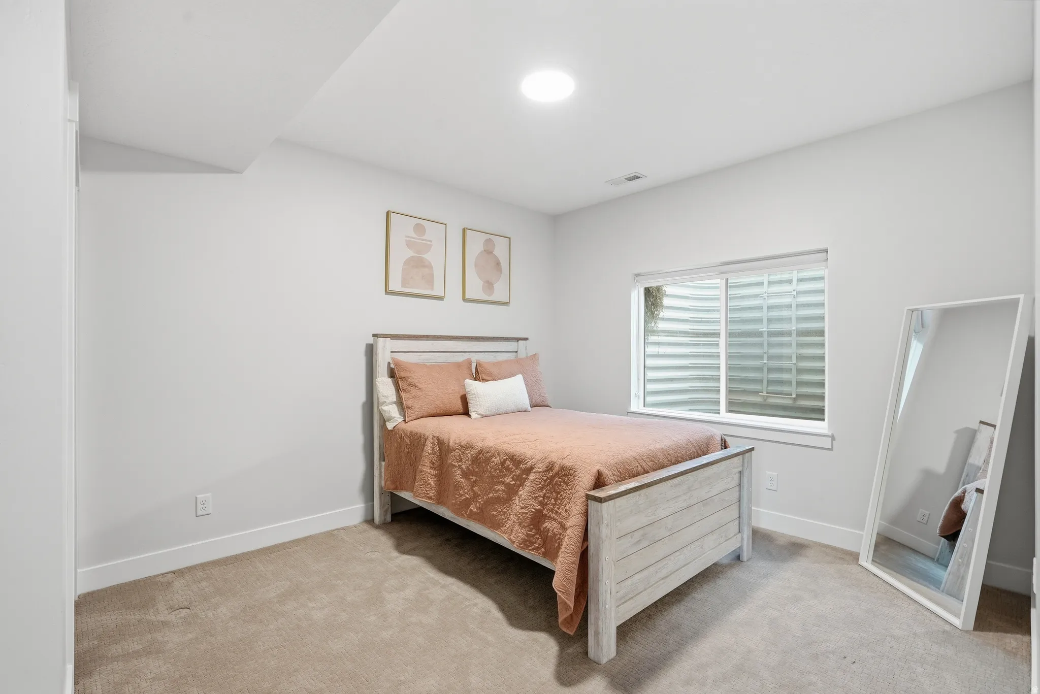 Carpeted room featuring a single window, recessed lighting, and white baseboards