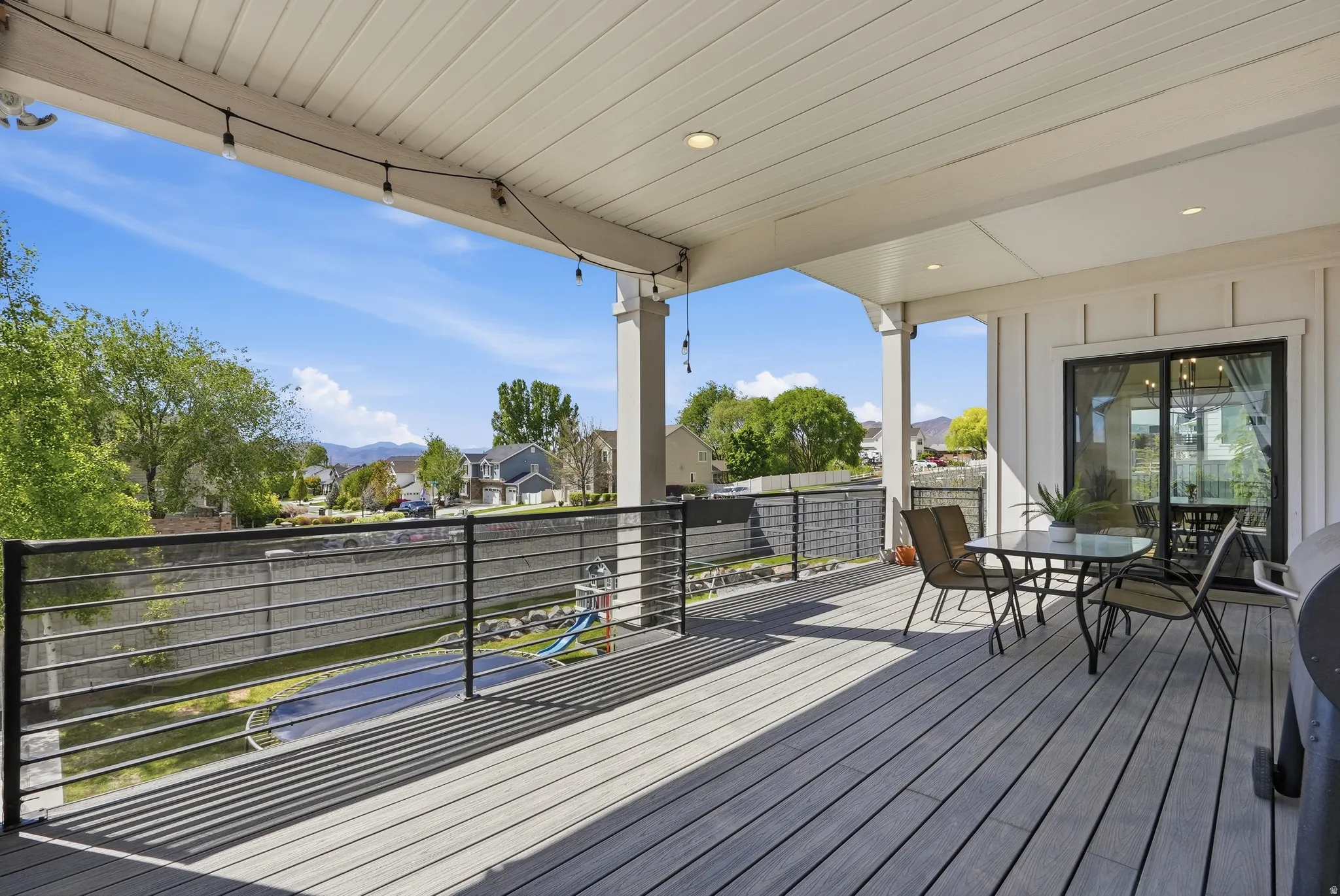Covered outdoor deck with composite wood-finish flooring