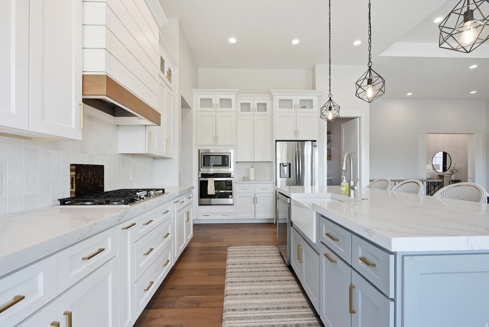 Open kitchen featuring an expansive center island with an integrated farmhouse sink