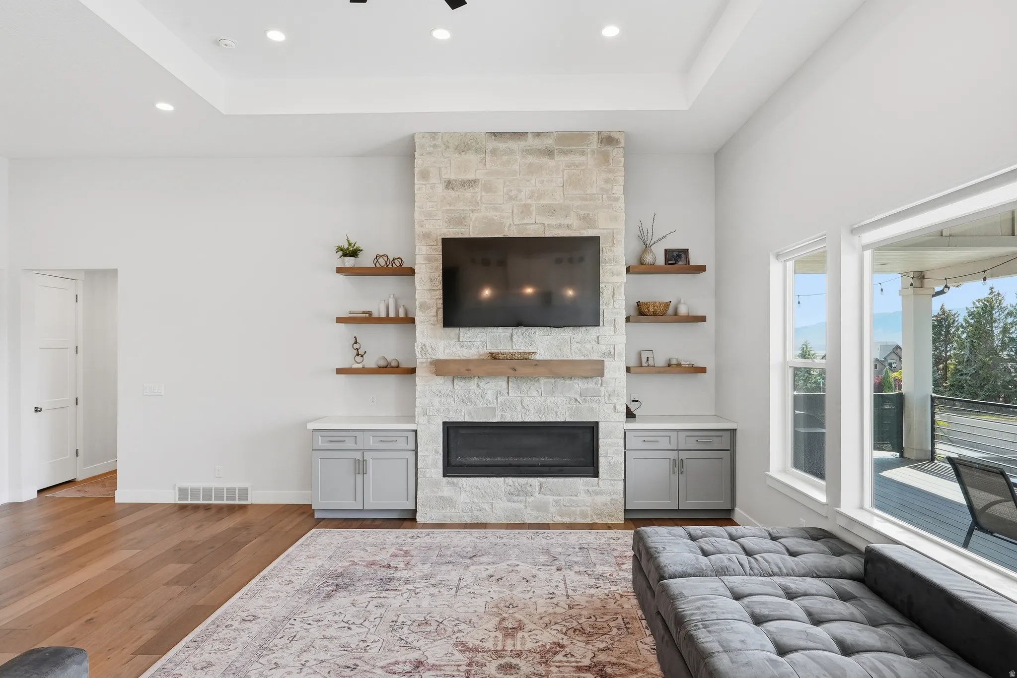 Living area with stone-clad fireplace and wood-finish flooring