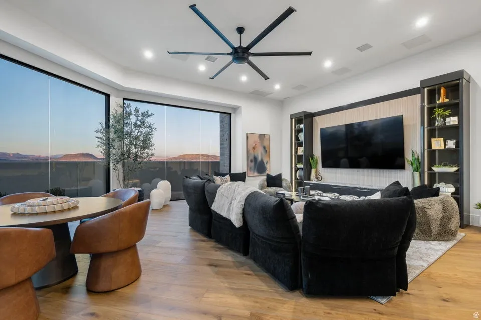 Expansive full-height windows frame the mountain backdrop