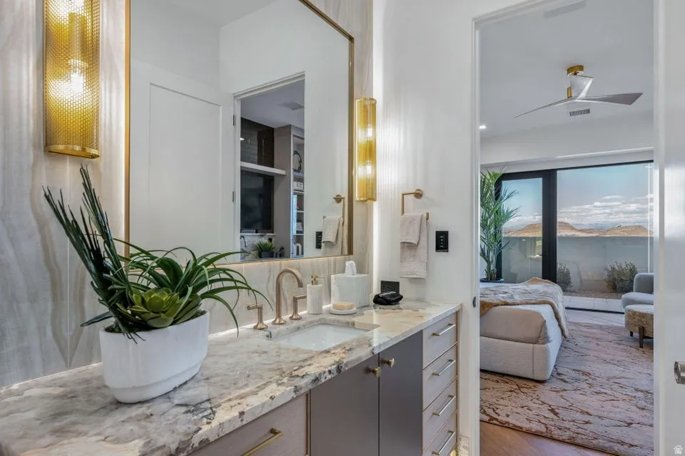 Contemporary vanity with a polished stone countertop and integrated sink