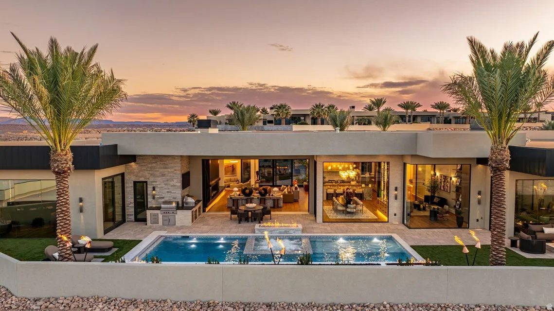 Modern exterior with a rectangular pool featuring integrated fire features and a spa