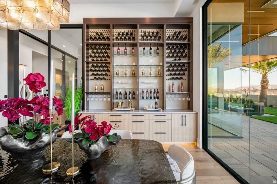 Built-in bar with extensive wine storage, integrated stemware racks, and a light-toned countertop