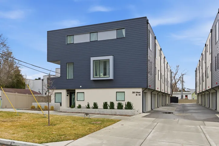 Modern architectural design featuring dark gray siding and light-colored stucco