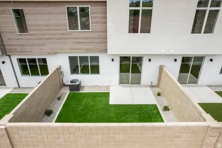 Contemporary exterior featuring a textured wood-finish facade and white stucco