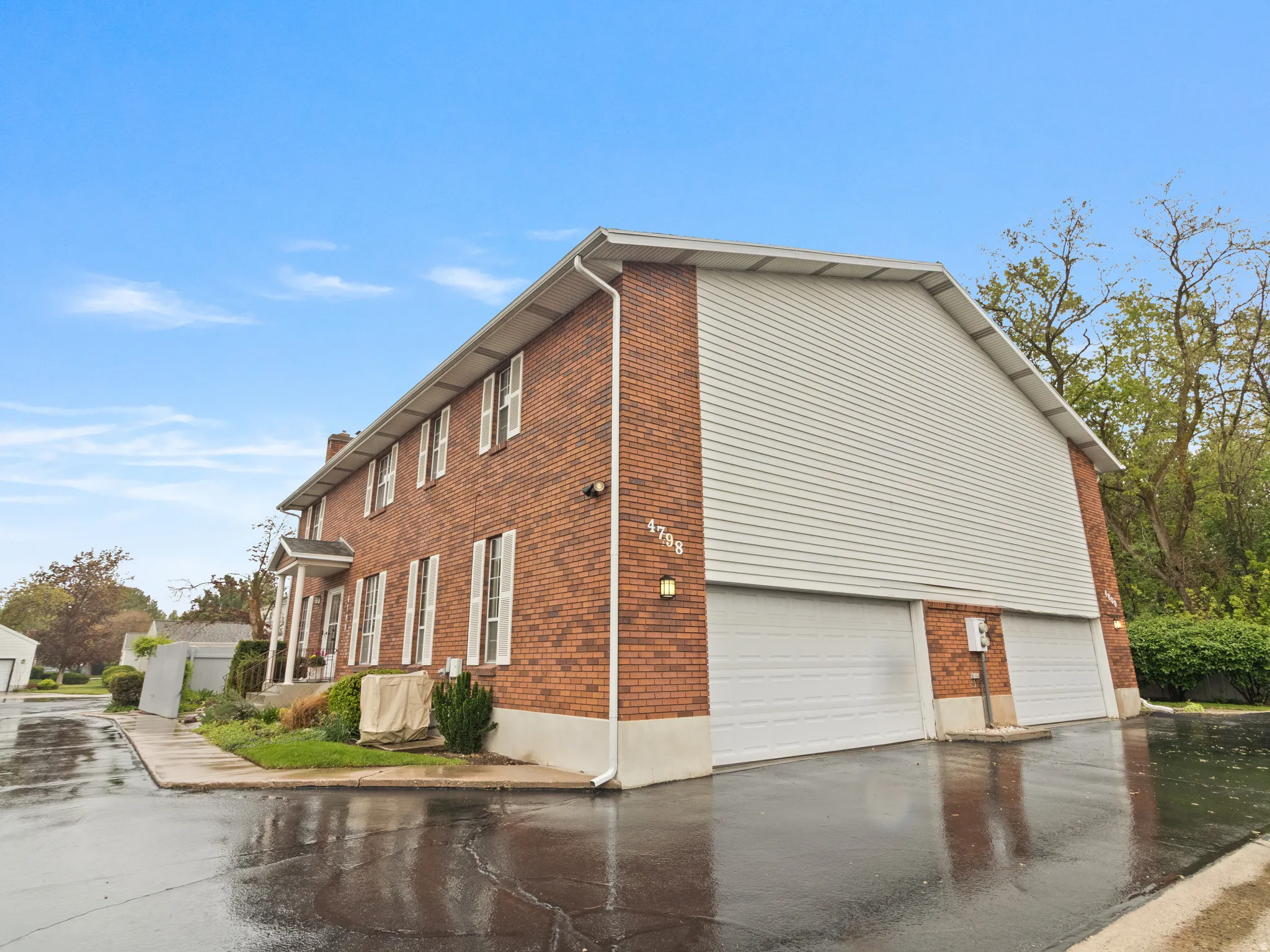 Brick exterior. Entrance to the two car garage.