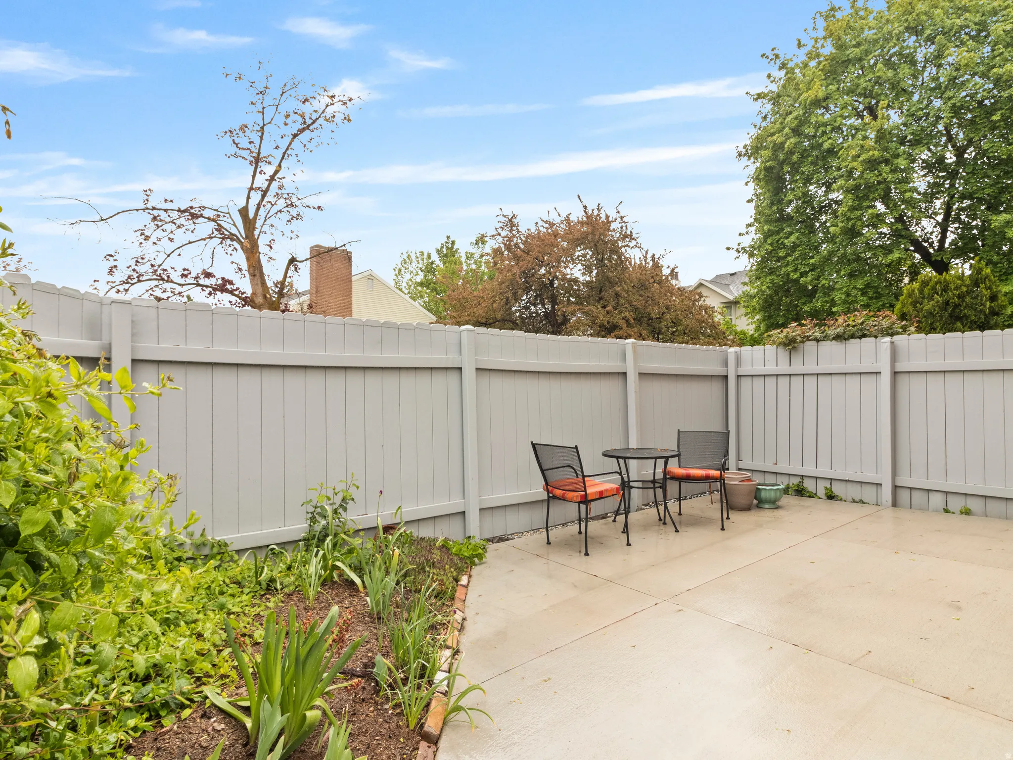 Private patio space featuring a concrete surface and a surrounding privacy fence