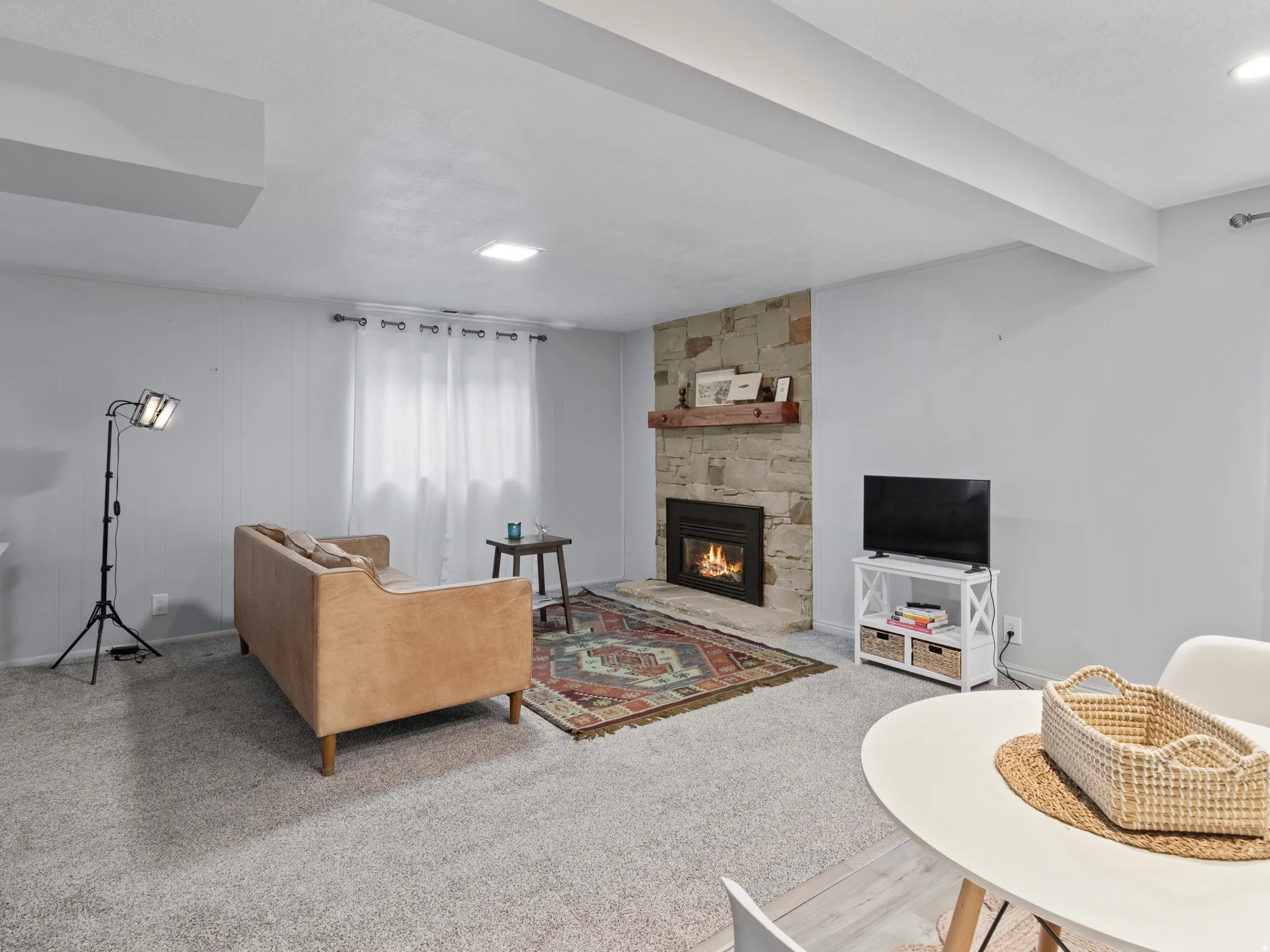 Stone-clad fireplace with a wood mantel