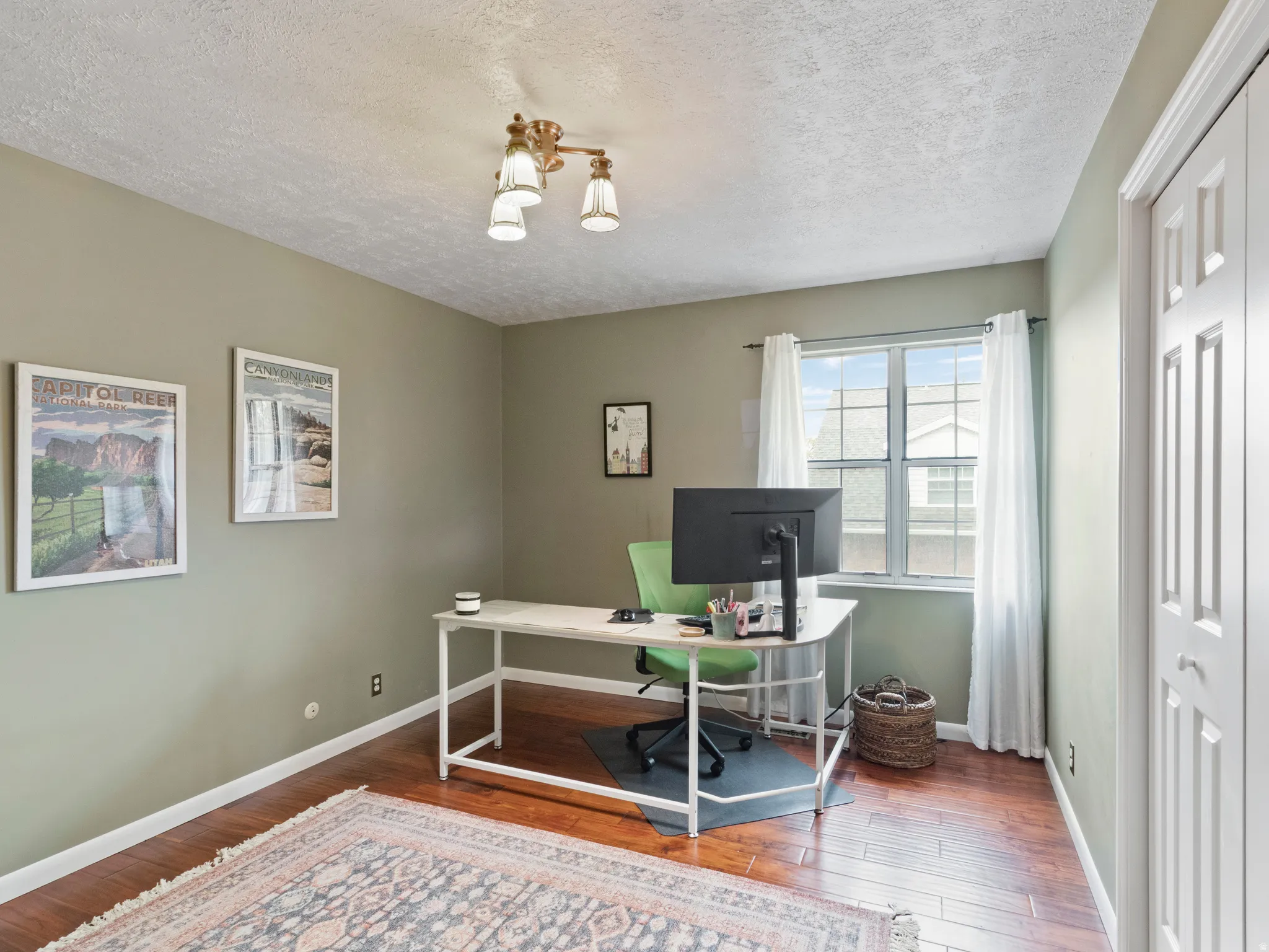 Large Bedroom. Great office space. Featuring wood-finish flooring and light green wall paint