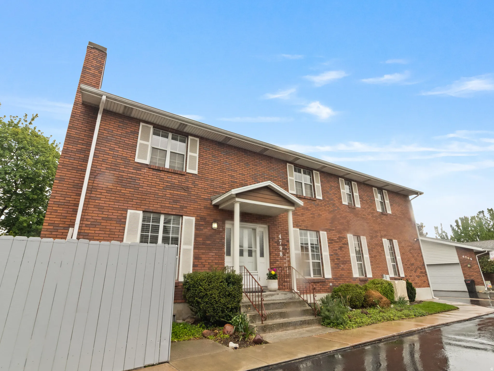 Brick exterior with white window shutters.