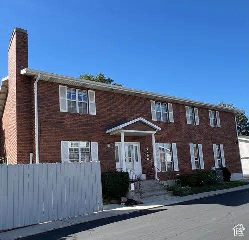 Brick exterior with white window shutters