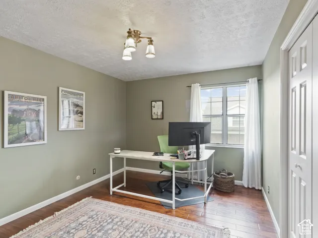 Large Bedroom. Great office space. Featuring wood-finish flooring and light green wall paint
