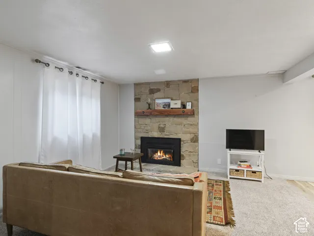 Stone-clad fireplace with a wood mantel