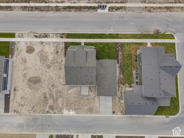 New construction lot featuring a partial concrete driveway and sidewalk access