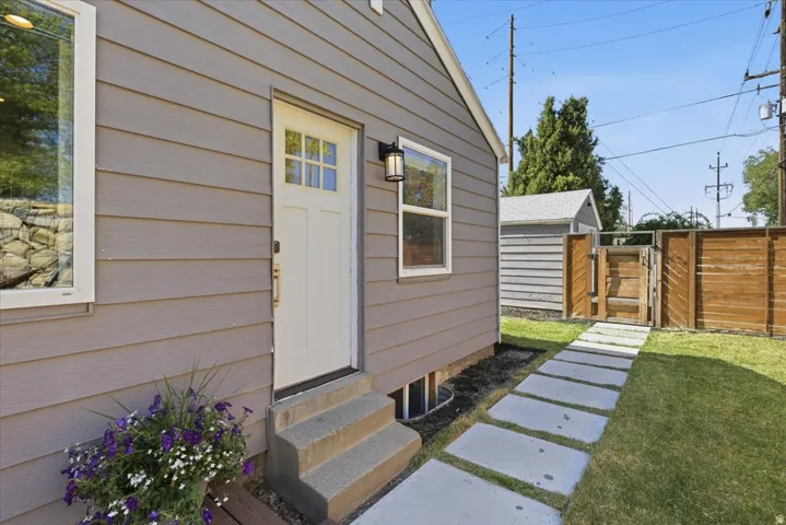 Gray horizontal siding with a white paneled door