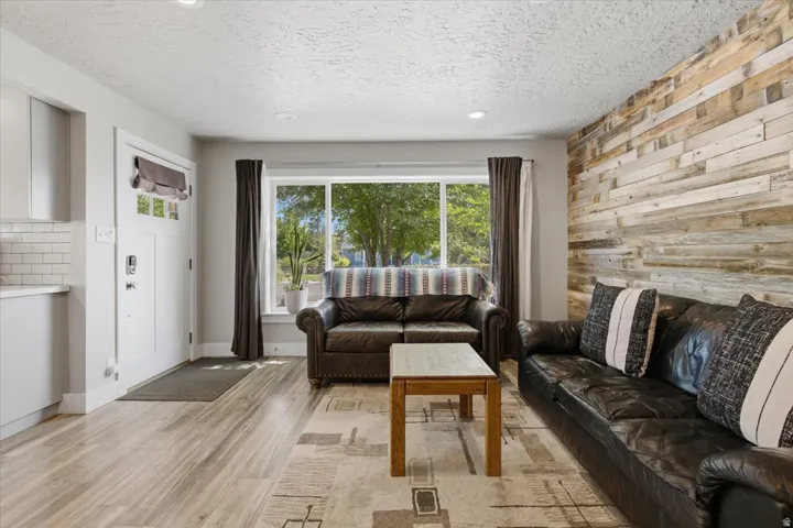 Living area featuring a prominent wood plank accent wall