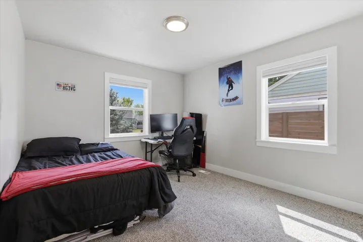 Light gray wall paint, textured ceiling, and light gray carpet