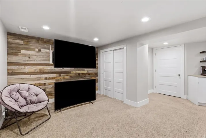 Reclaimed wood-finish accent wall with integrated media mounts