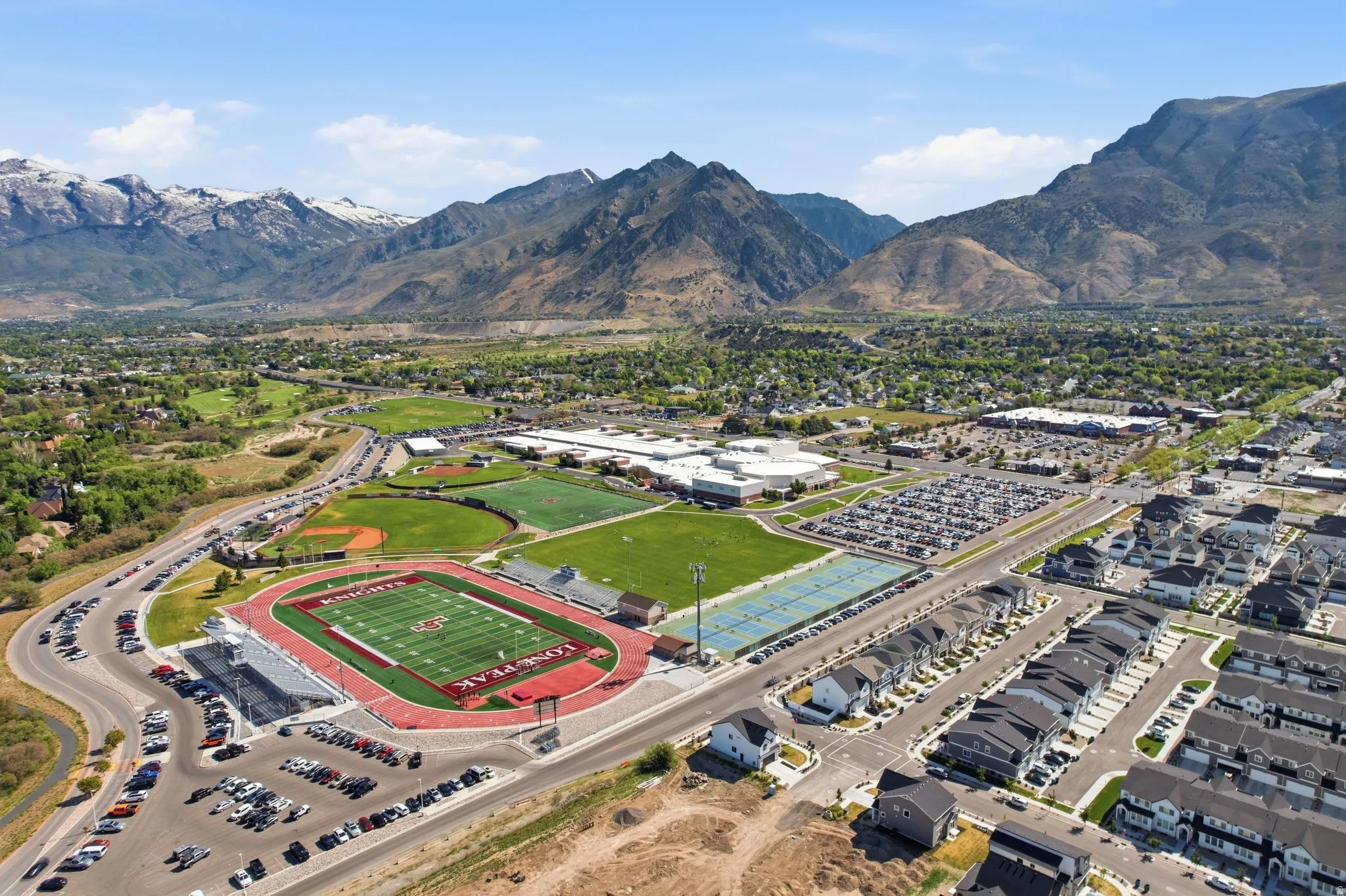 Aerial perspective showcasing a residential development with mountain backdrops
