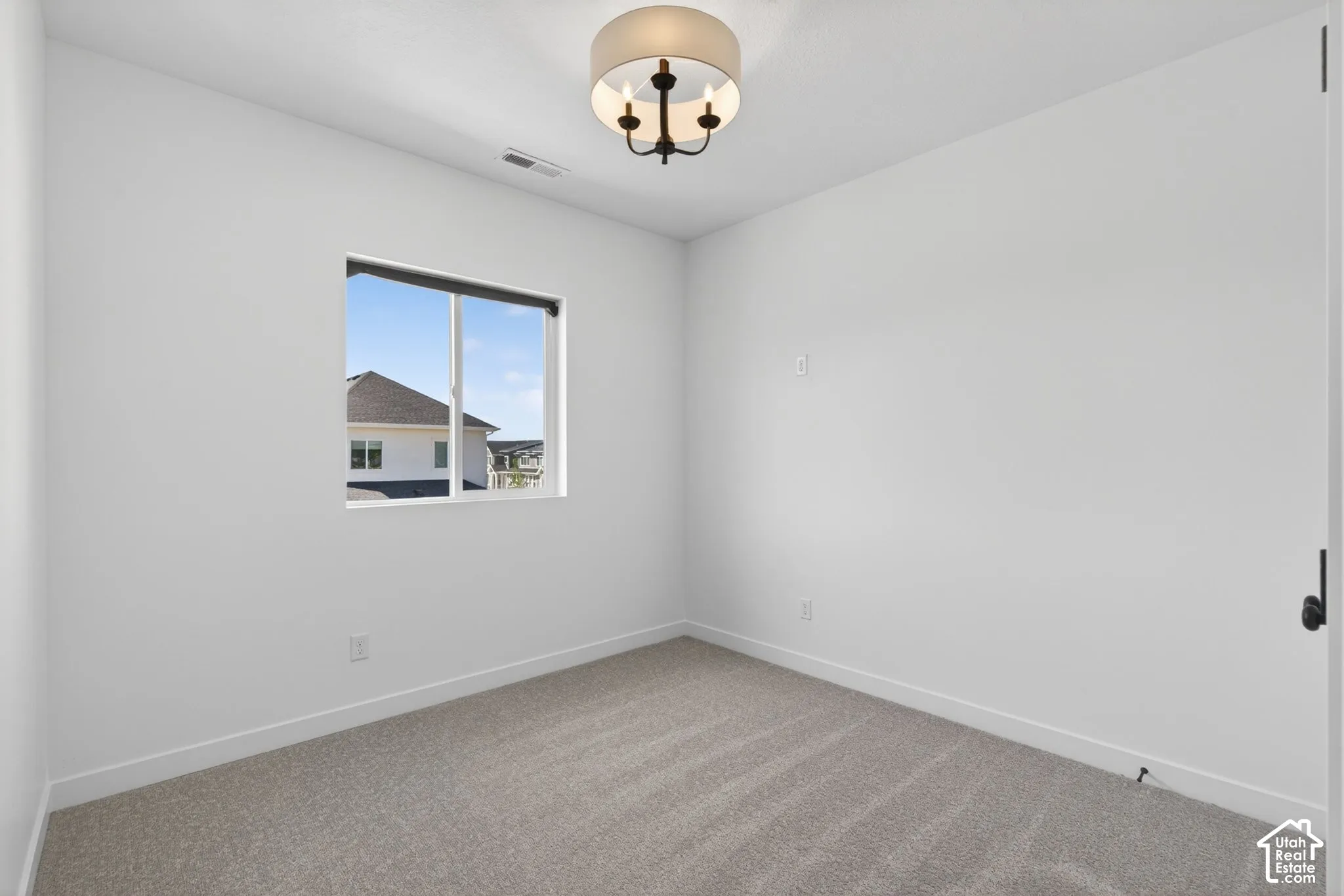 Neutral-toned carpet flooring complements the white walls and trim