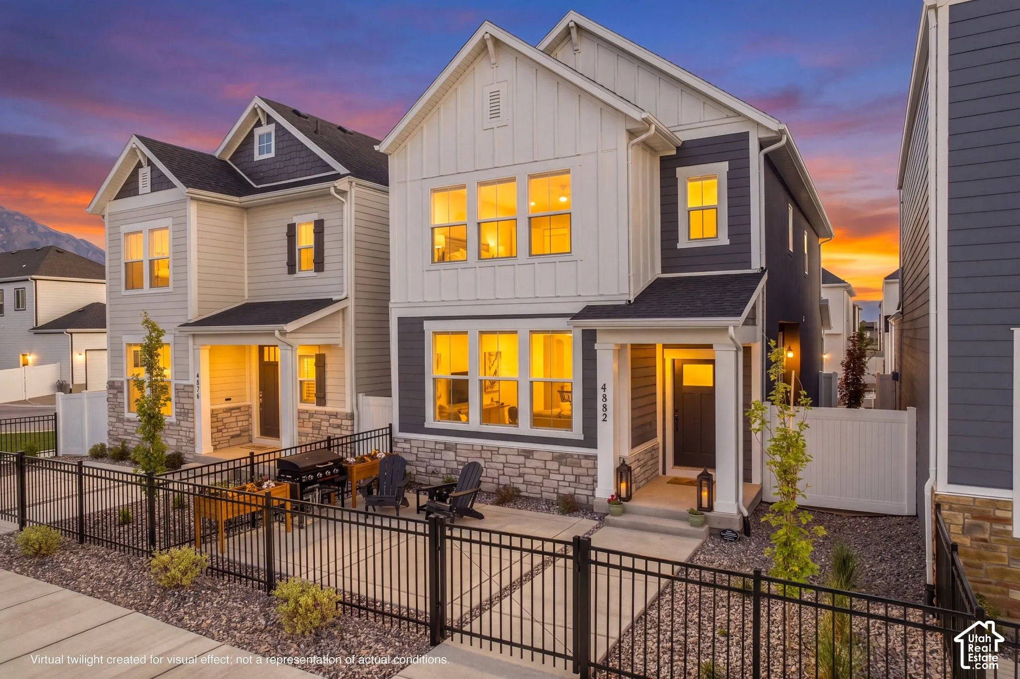 Modern craftsman-style exterior featuring board and batten siding, stone facade accents, and a covered entryway