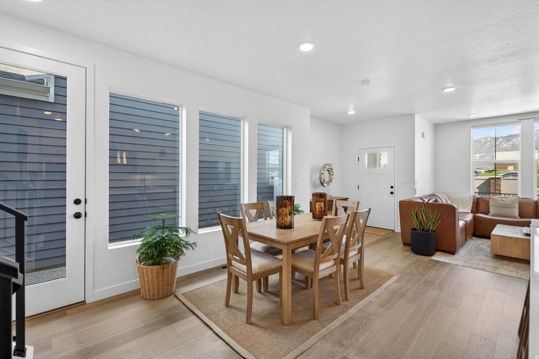 Open-concept living space featuring wood-finish flooring, recessed lighting, and white trim