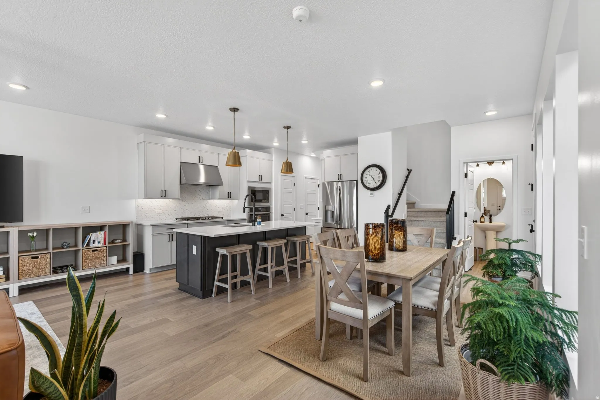 Kitchen and dining area featuring light wood-finish flooring, recessed lighting, and a white ceiling