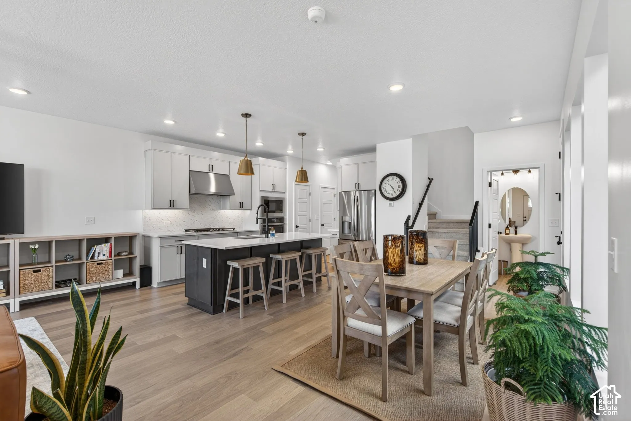 Kitchen and dining area featuring light wood-finish flooring, recessed lighting, and a white ceiling