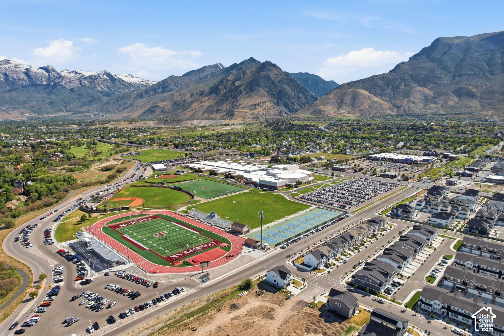 Aerial perspective showcasing a residential development with mountain backdrops