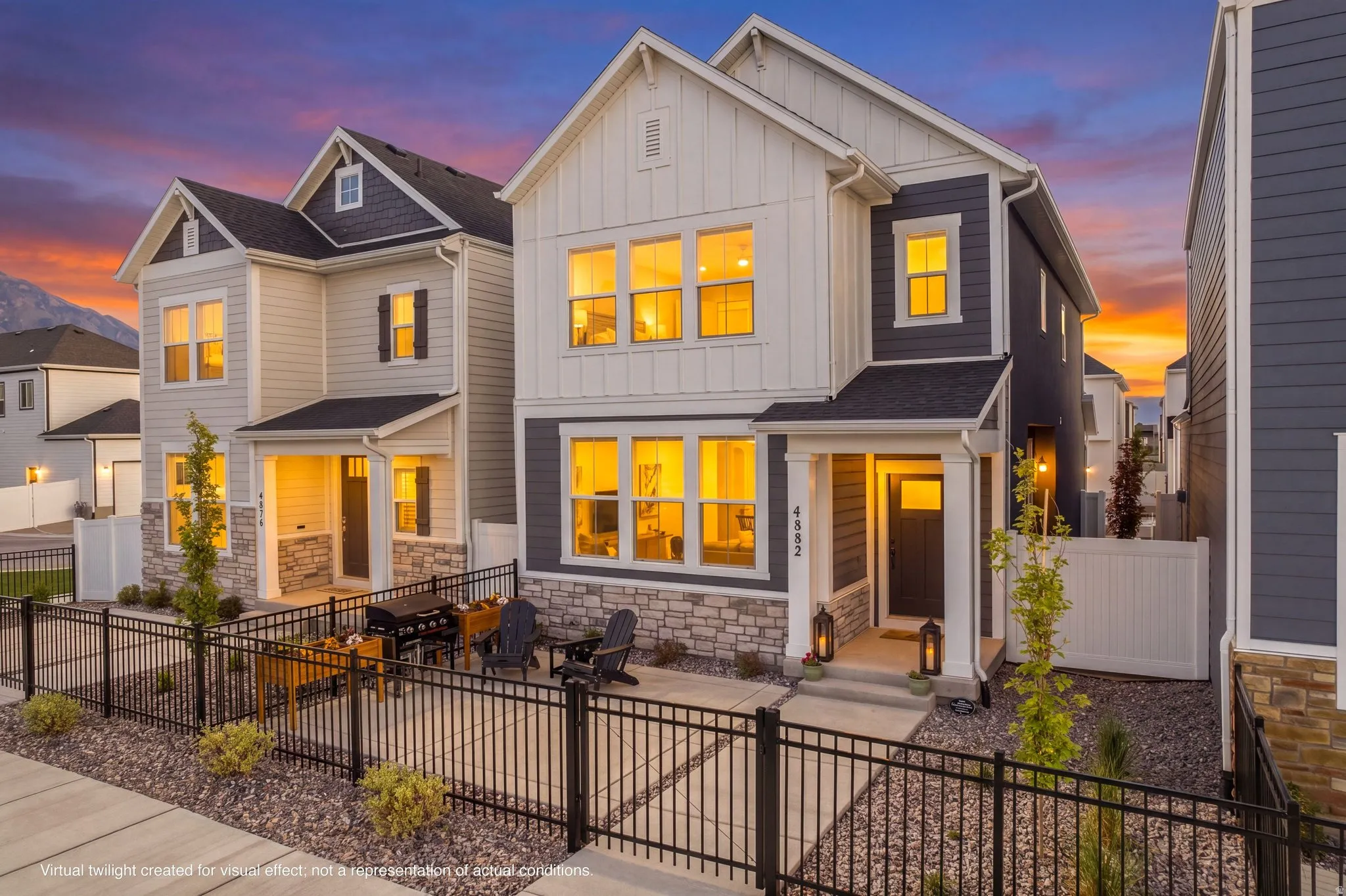 Modern craftsman-style exterior featuring board and batten siding, stone facade accents, and a covered entryway