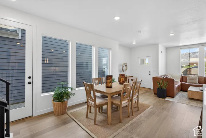 Open-concept living space featuring wood-finish flooring, recessed lighting, and white trim