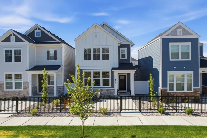 Modern detached home featuring a board and batten facade with stone accents