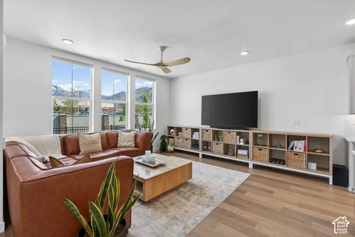 Living area with three large windows providing abundant natural light and mountain scenery