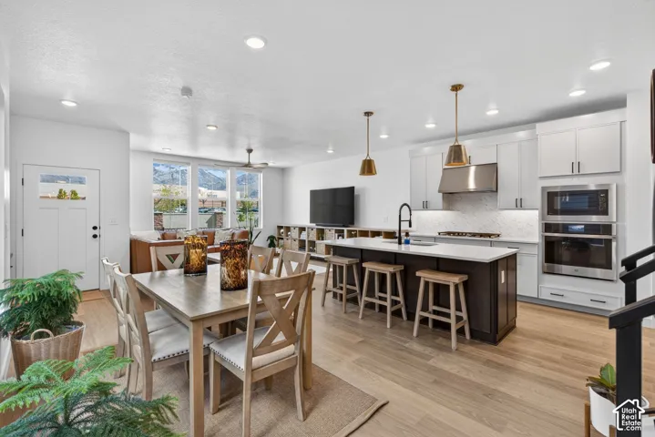 Open-concept living space featuring wood-finish flooring, recessed lighting, and a contemporary kitchen