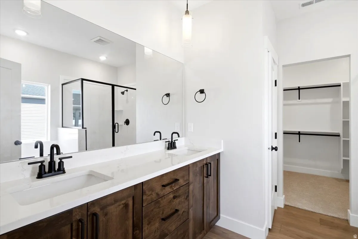 Primary bathroom. Double vanity with quartz countertops and integrated sinks