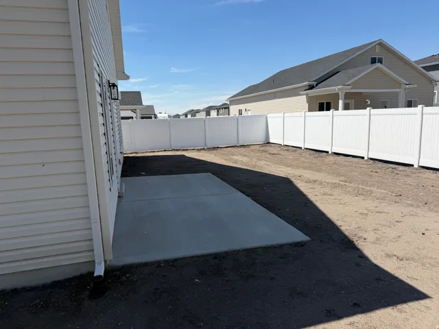Concrete patio with a privacy fence