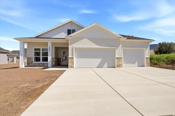 Contemporary residence featuring light-colored siding and stone accents