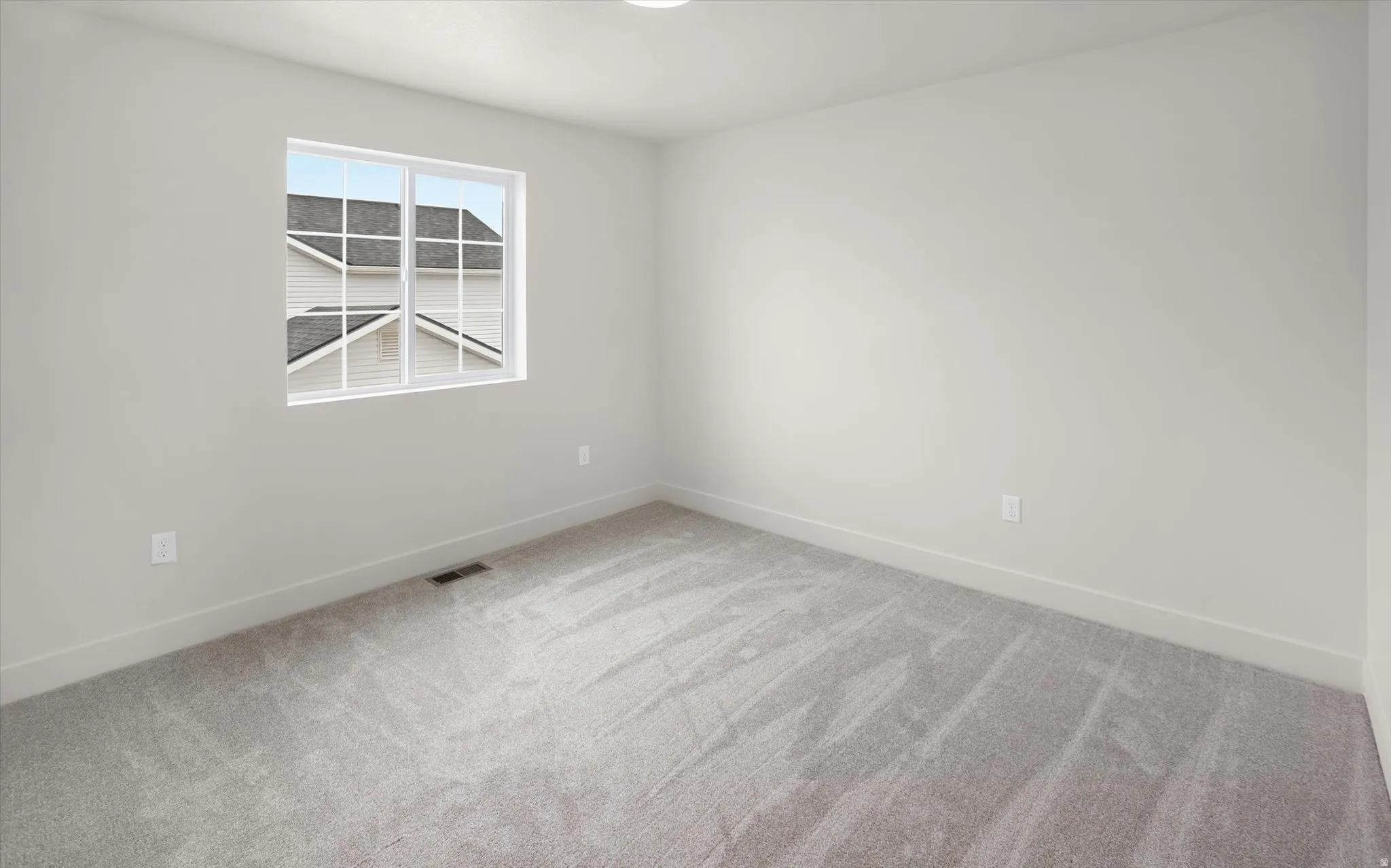 Light gray carpeting paired with white baseboards