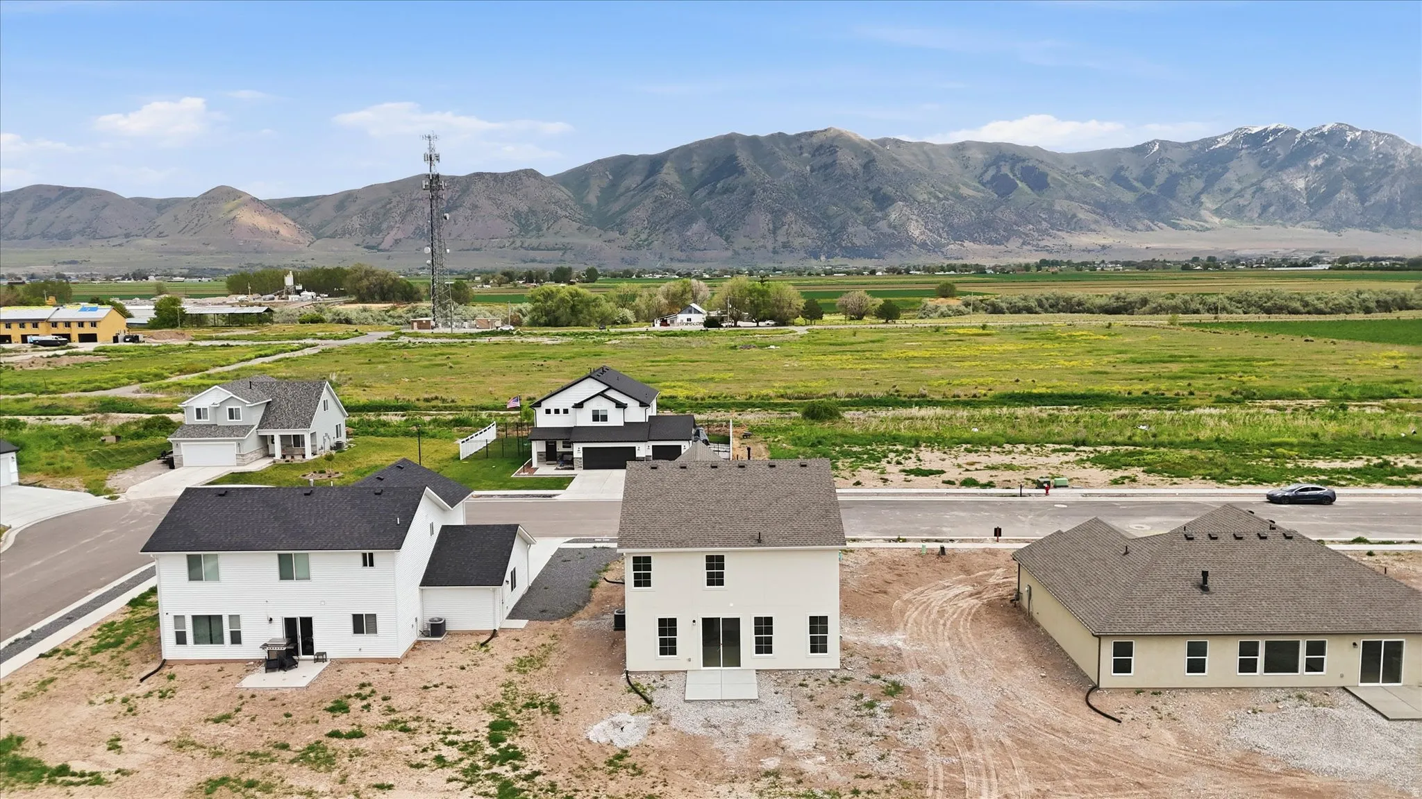 Newly constructed two-story residence featuring a white exterior and dark shingle roofing