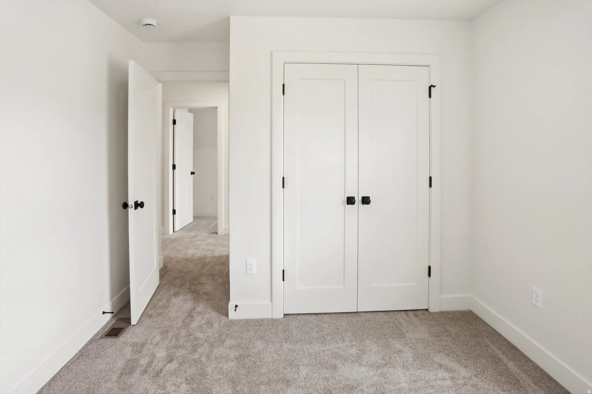 Plush grey carpeting and white walls with white trim
