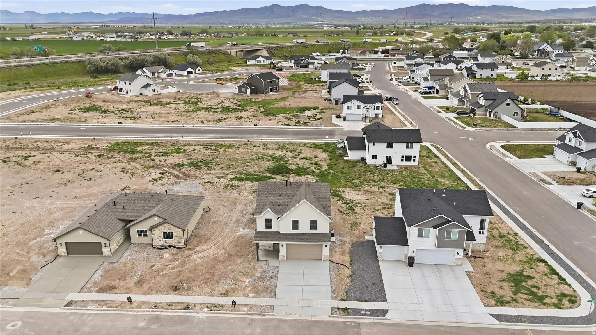 New construction community featuring diverse architectural styles and paved streets